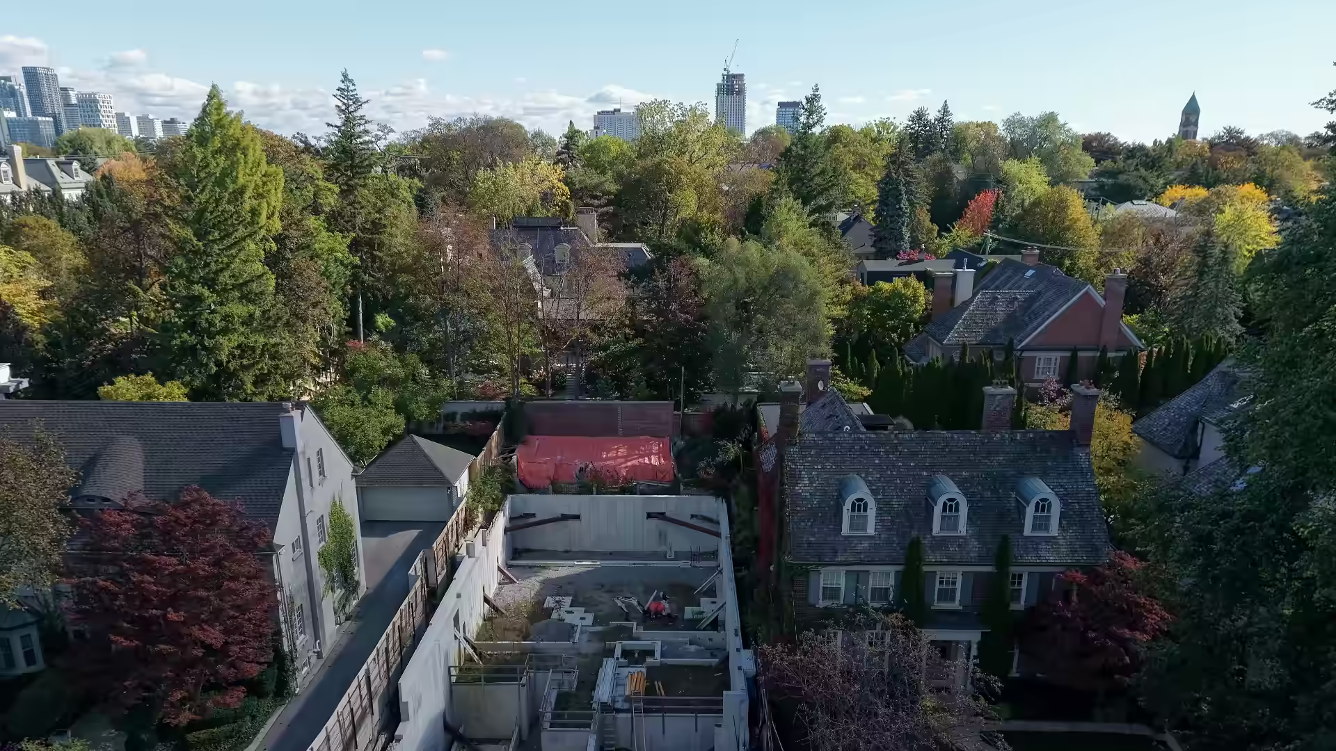 Drone view over an open house-foundation excavation in Forest Hill South, Toronto, before backfill