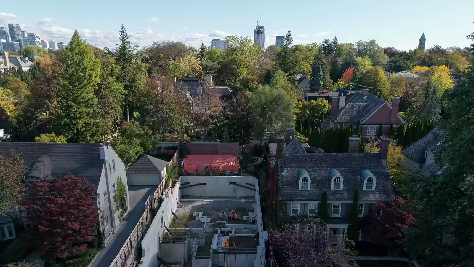 Drone view over a house-foundation excavation in Forest Hill South, Toronto; the loop goes on to a new build in the Bridle Path and its 3D model